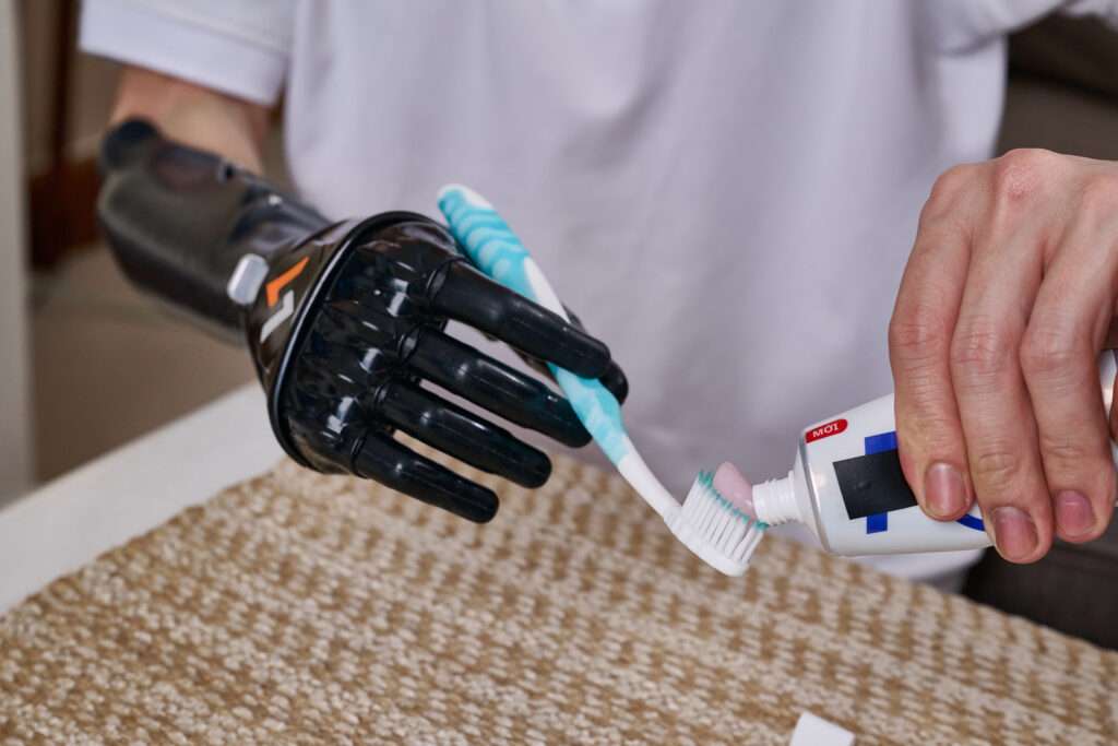 Using Vulcan Prosthetic Hand with Tripod Grip to hold toothpaste when placing cream on your toothbrush