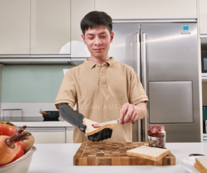 User using Vulcan Prosthetic Arm to make sandwich